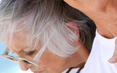 A photo of an elderly couple - the man is smiling at the camera, but the women looks away, seeming sad. This page is for Vaginal Fillers, one of the Menopause-related treatments at The Women's Clinic